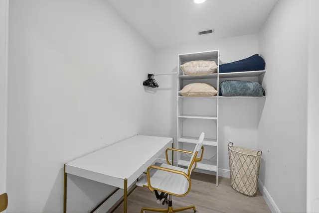 a bedroom with two beds and painting on the wall