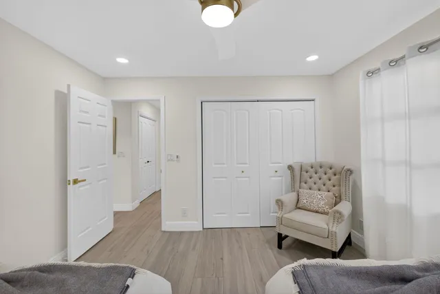 a bathroom with a granite countertop sink a toilet mirror and bathtub
