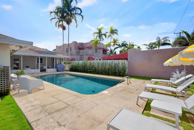 a view of a house with wooden fence