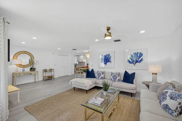 a living room with furniture a fireplace and wooden floor