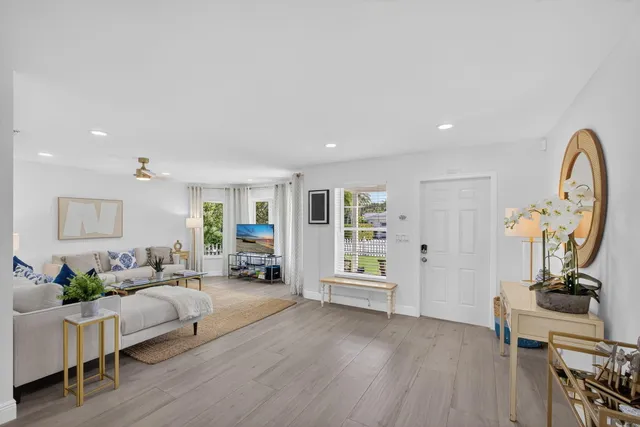a dining room with furniture a chandelier and wooden floor