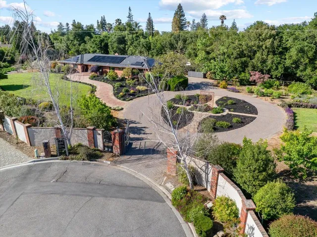 a view of a house with swimming pool and sitting area