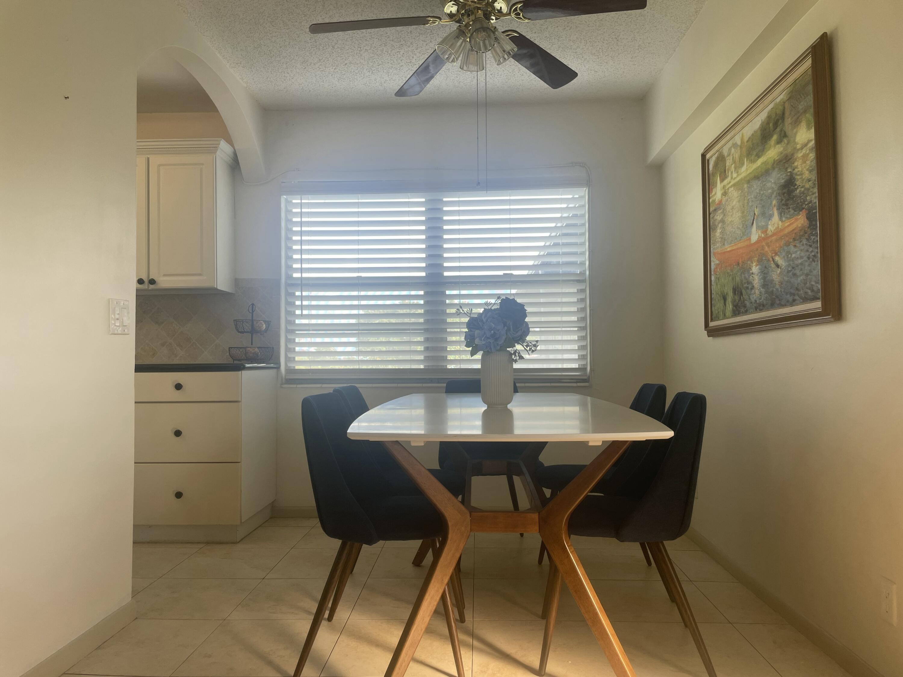 243 Suffolk F Boca Raton, FL 33434 - Photo 7 of 12 a view of a dining room with furniture and window