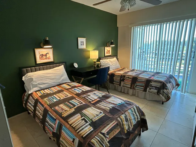 a bedroom with two beds and a chandelier