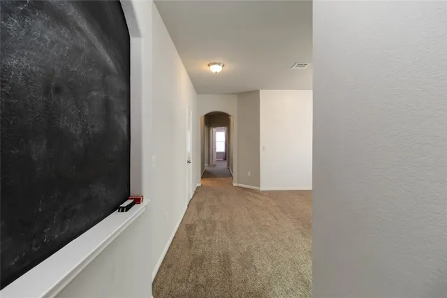 an empty room with windows and bathroom view