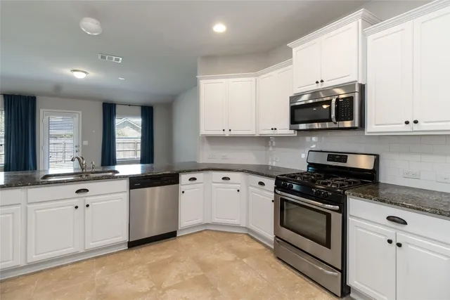 a white refrigerator freezer sitting inside of a kitchen