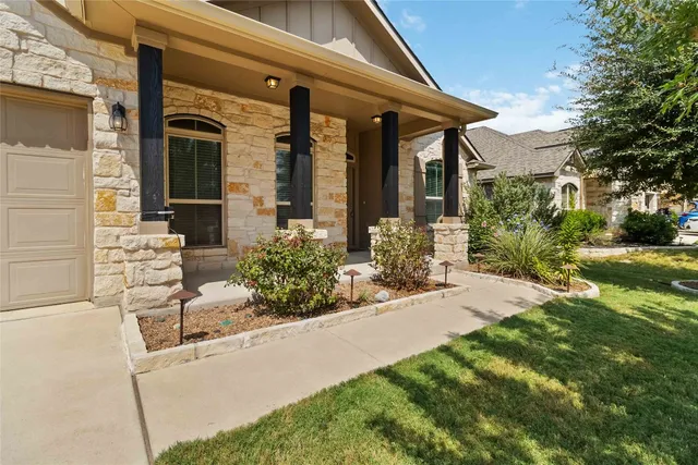a view of a house with backyard and porch