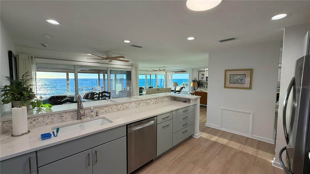 2709 Casey Key Road Nokomis, FL 34275 - Photo 15 of 64 a kitchen with granite countertop a sink and a refrigerator