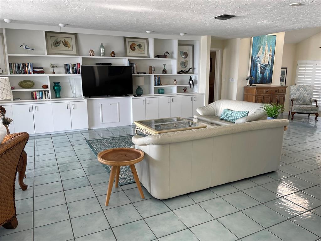 2709 Casey Key Road Nokomis, FL 34275 - Photo 16 of 40 a living room with furniture and a flat screen tv