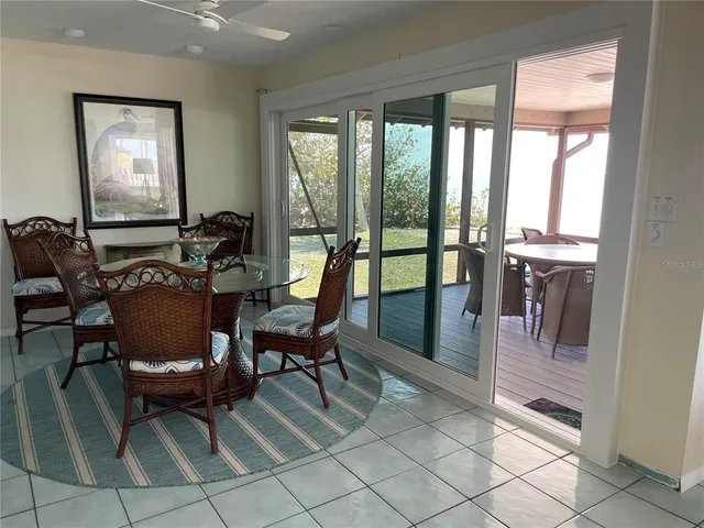 a dining room with furniture a chandelier and wooden floor