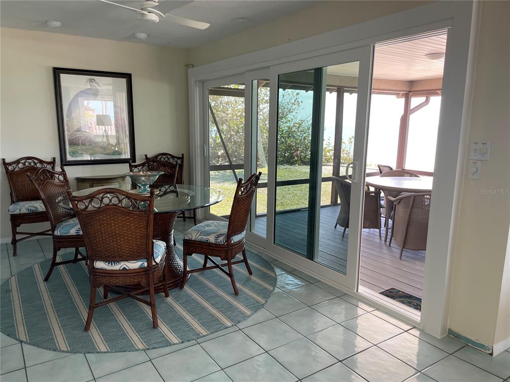 2709 Casey Key Road Nokomis, FL 34275 - Photo 21 of 40 a living room with furniture and a floor to ceiling window