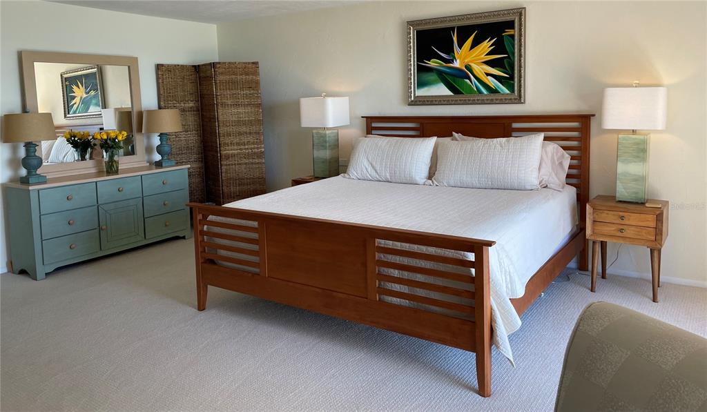 2709 Casey Key Road Nokomis, FL 34275 - Photo 23 of 40 a bedroom with a bed and painting on the wall