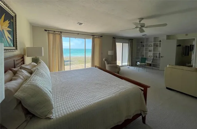 a spacious bedroom with a bed and large windows