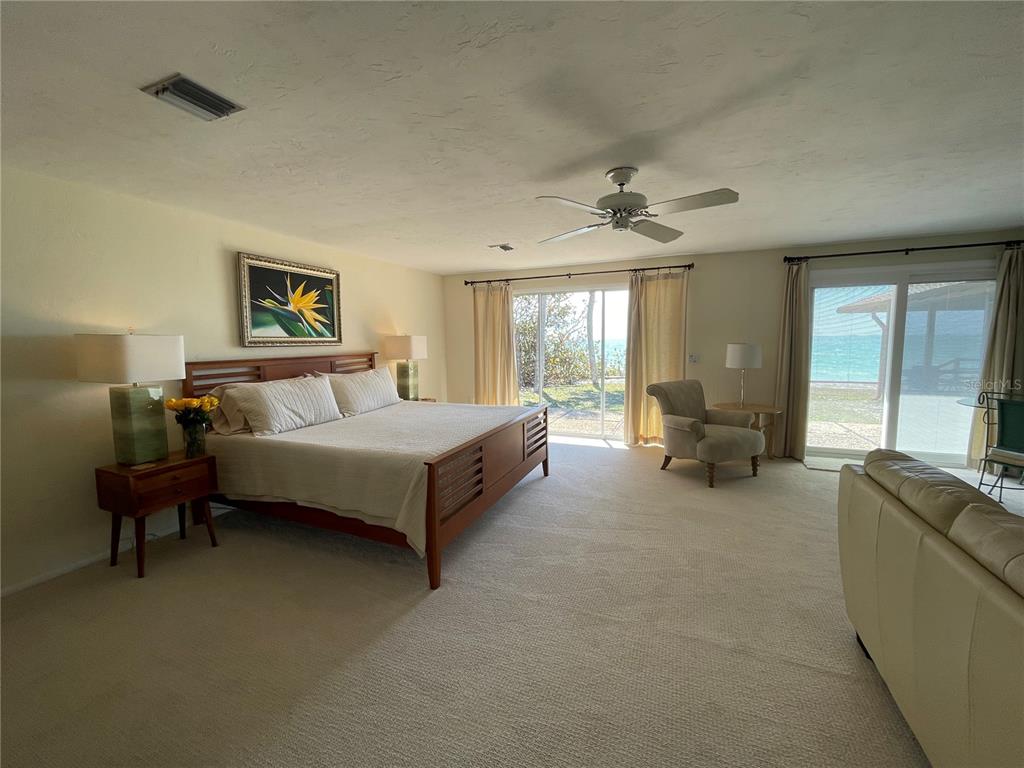 2709 Casey Key Road Nokomis, FL 34275 - Photo 25 of 40 a spacious bedroom with a bed and large windows