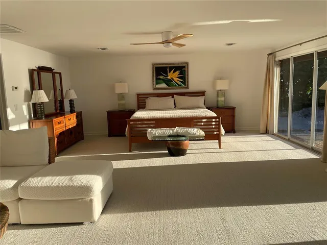 a bedroom with 2 bed and a painting on the wall