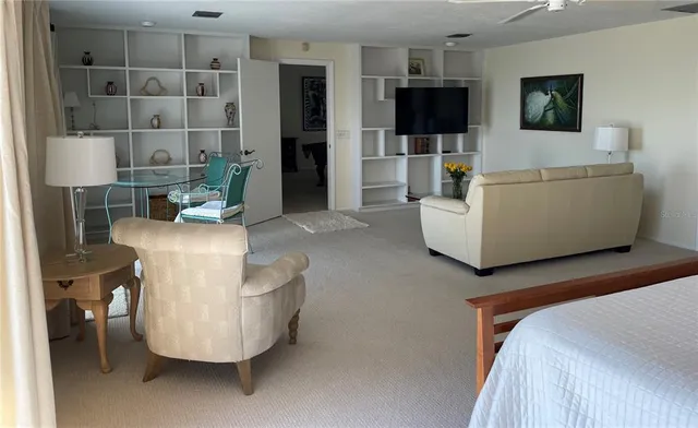 a large white kitchen with a sink a stove and cabinets
