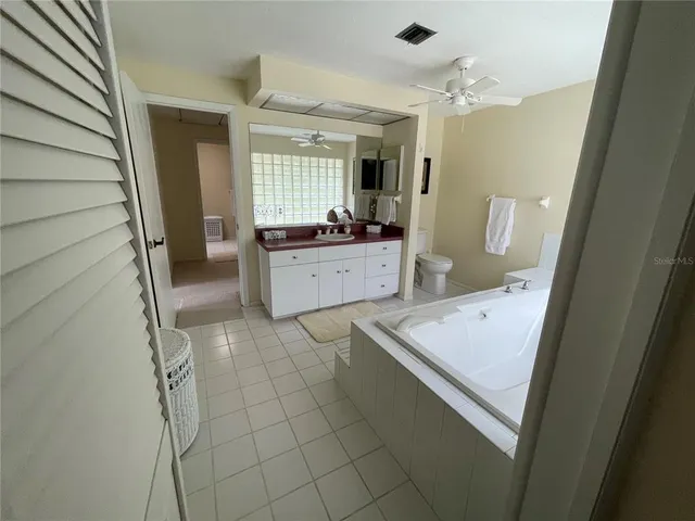 a bedroom with a bed and a mirror