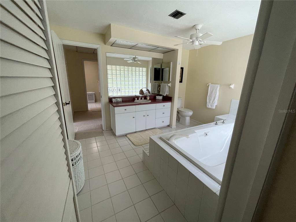 2709 Casey Key Road Nokomis, FL 34275 - Photo 28 of 40 a large white kitchen with a sink a stove and cabinets