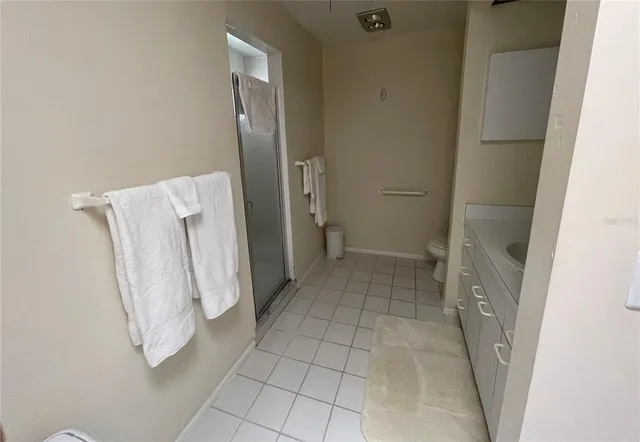 a bedroom with a bed couch and a window