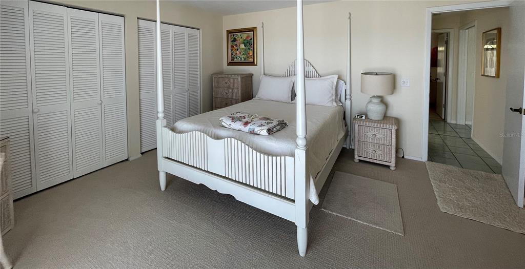 2709 Casey Key Road Nokomis, FL 34275 - Photo 31 of 40 a bedroom with a bed and a mirror