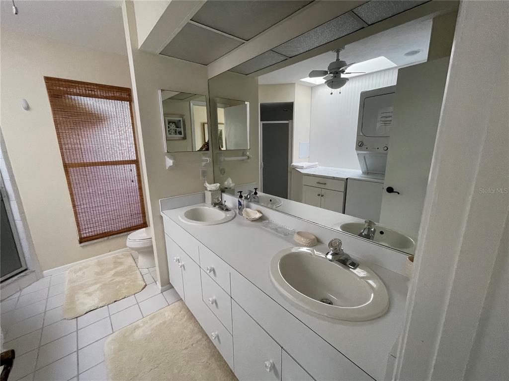 2709 Casey Key Road Nokomis, FL 34275 - Photo 37 of 40 a bathroom with a sink a toilet and mirror