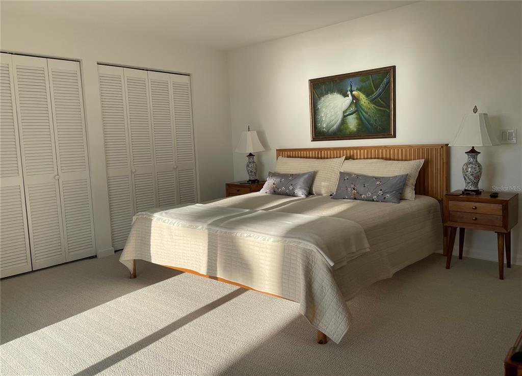 2709 Casey Key Road Nokomis, FL 34275 - Photo 39 of 64 a bedroom with a bed and a painting on the wall