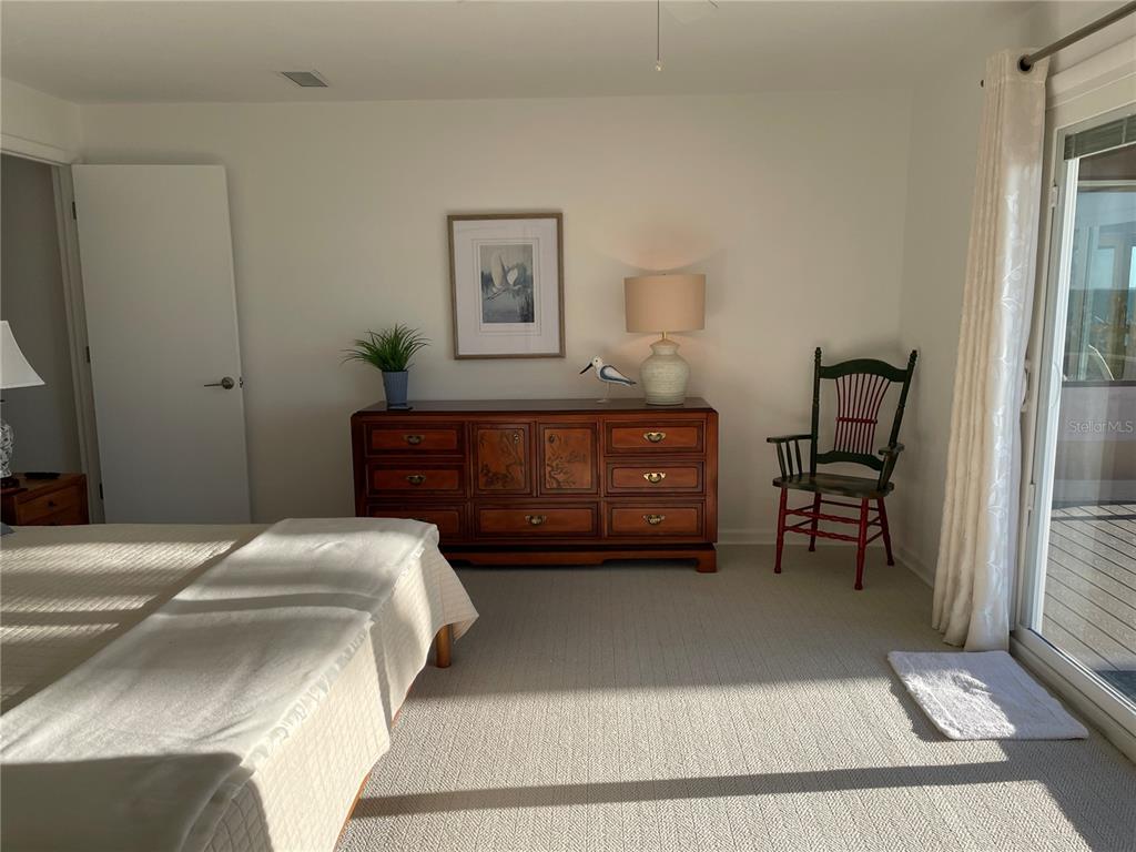 2709 Casey Key Road Nokomis, FL 34275 - Photo 42 of 64 a bedroom with a bed and a cabinets