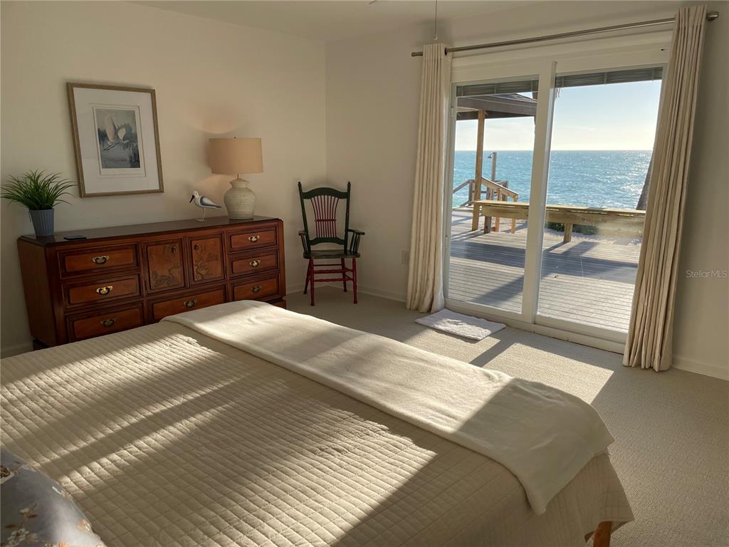 2709 Casey Key Road Nokomis, FL 34275 - Photo 43 of 64 a bedroom with a bed and a dresser next to a window