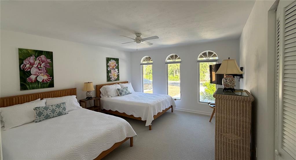 2709 Casey Key Road Nokomis, FL 34275 - Photo 51 of 64 a bedroom with two beds and painting on the wall