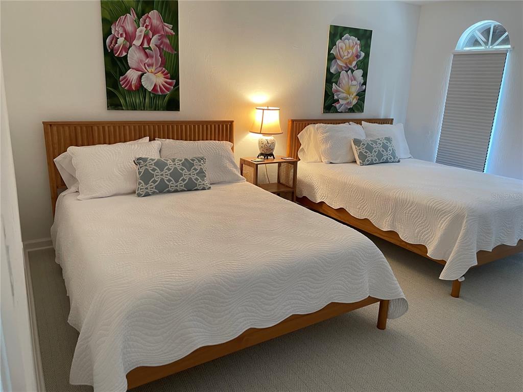 2709 Casey Key Road Nokomis, FL 34275 - Photo 52 of 64 a bedroom with 2 bed and a painting on the wall