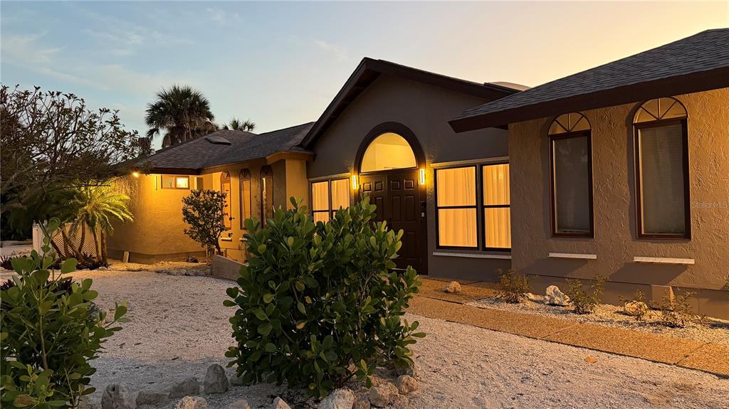 2709 Casey Key Road Nokomis, FL 34275 - Photo 55 of 64 a front view of a house with a yard