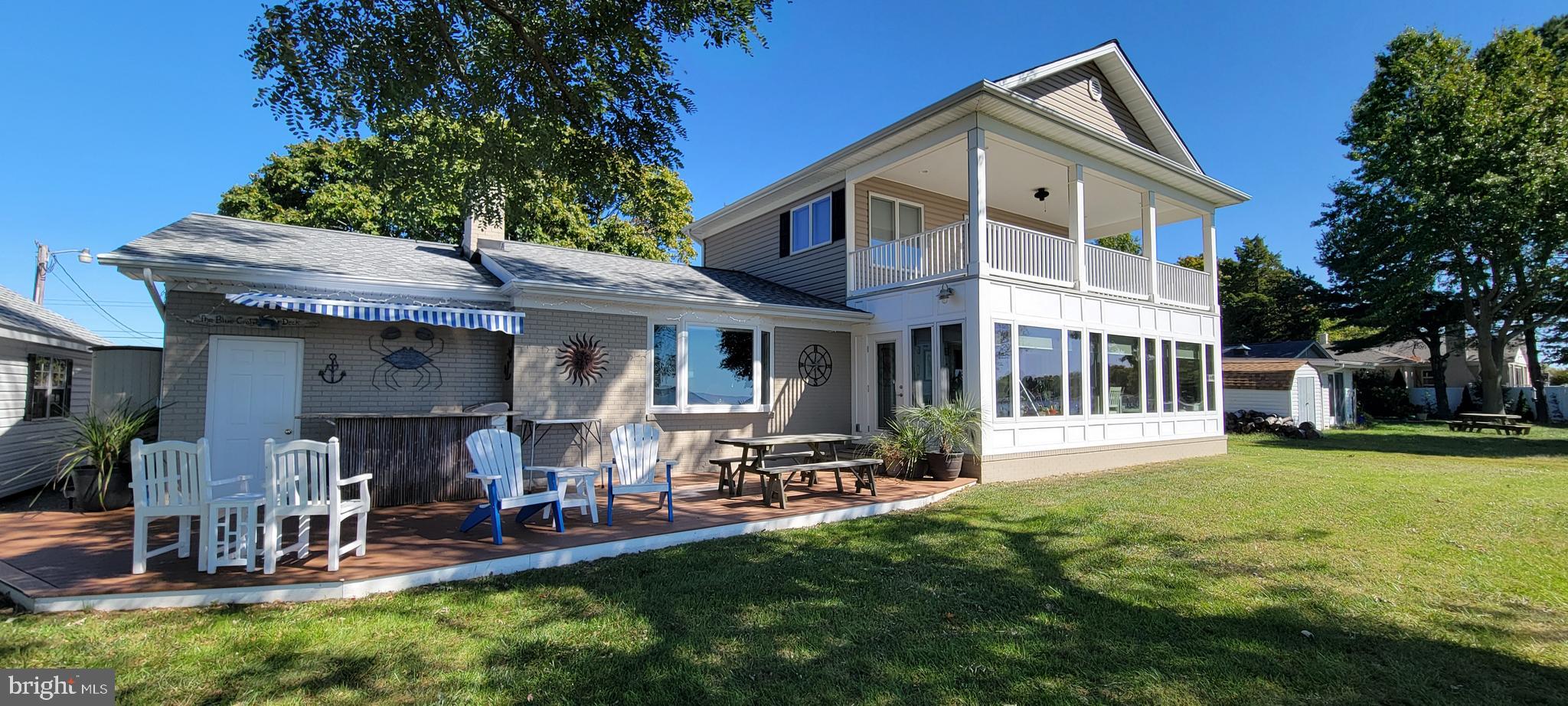 a front view of a house with a garden and sitting area