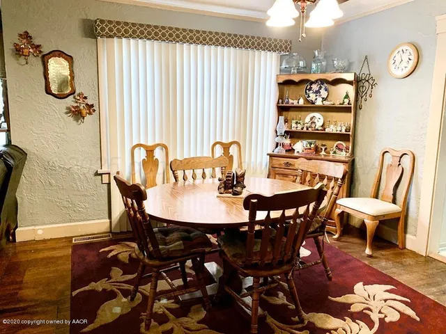 a view of a dining room with furniture and chandelier