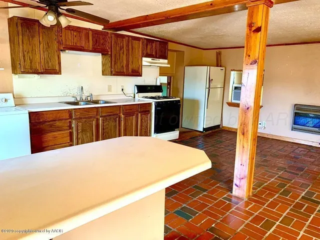 a kitchen with stainless steel appliances a refrigerator and a stove top oven