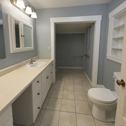 a bathroom with a sink a toilet and mirror