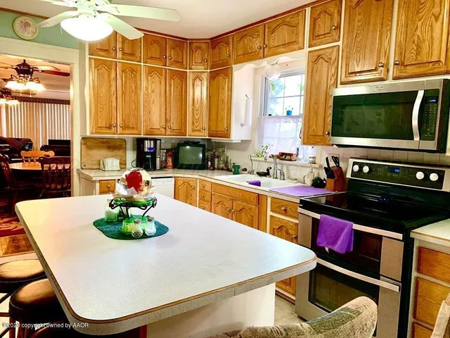 a kitchen with a stove a sink and a microwave