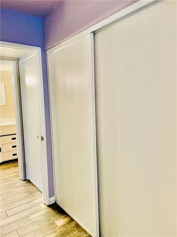 a view of a bedroom with a bed and cabinet