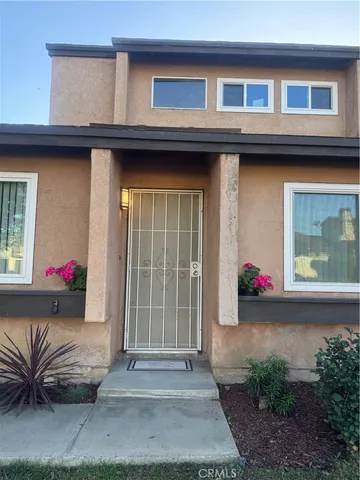 a view of backyard with large tree and wooden fence