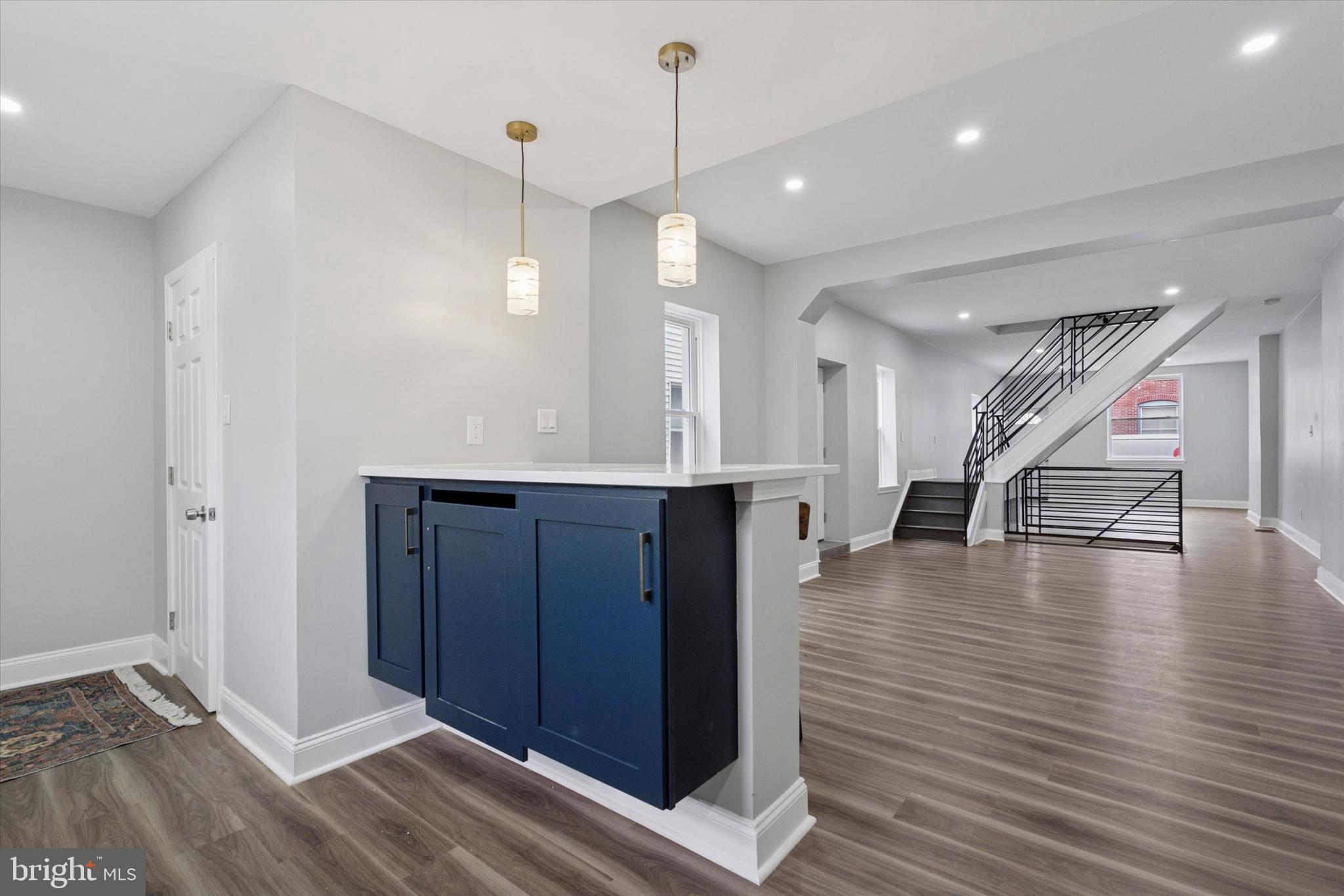 3448 Amber Street Philadelphia, PA 19134 - Photo 14 of 29 a view of a room with wooden floor staircase and a kitchen