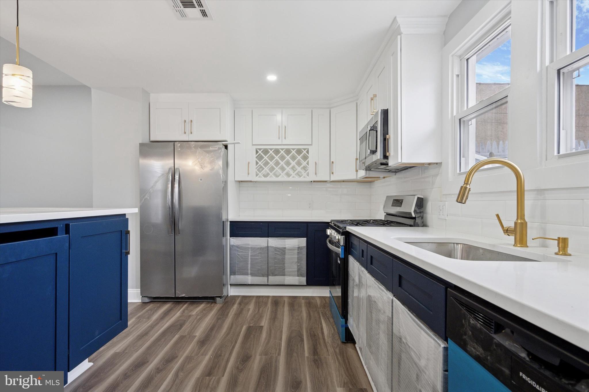 3448 Amber Street Philadelphia, PA 19134 - Photo 15 of 29 a kitchen with stainless steel appliances granite countertop a sink stove and refrigerator