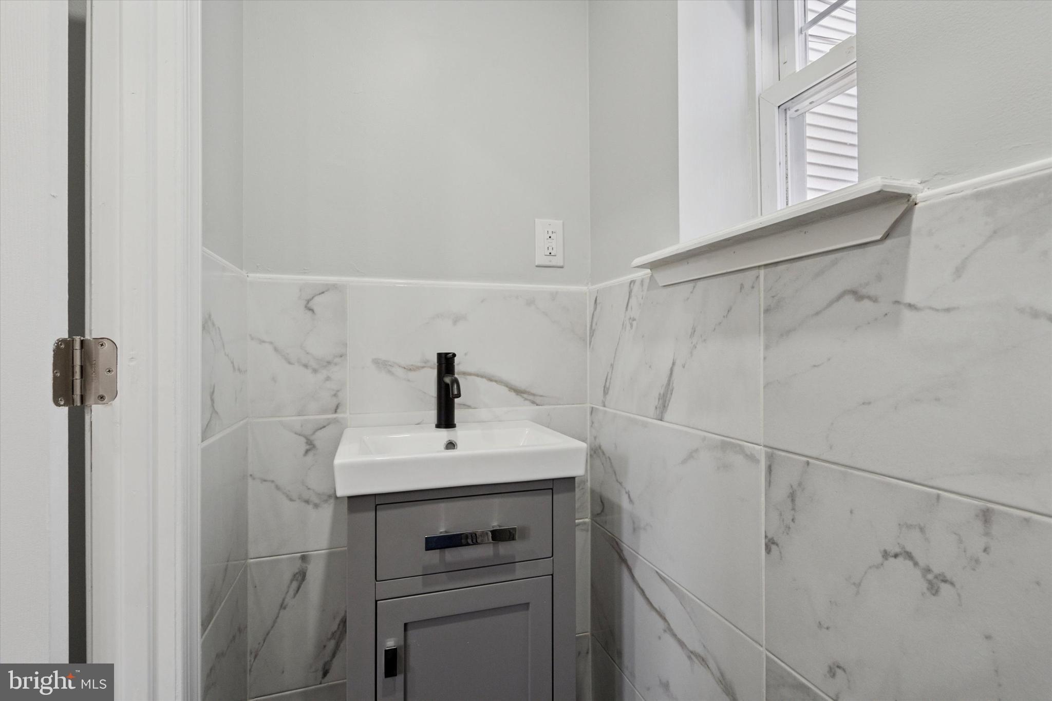 3448 Amber Street Philadelphia, PA 19134 - Photo 17 of 29 a bathroom with a sink vanity and window