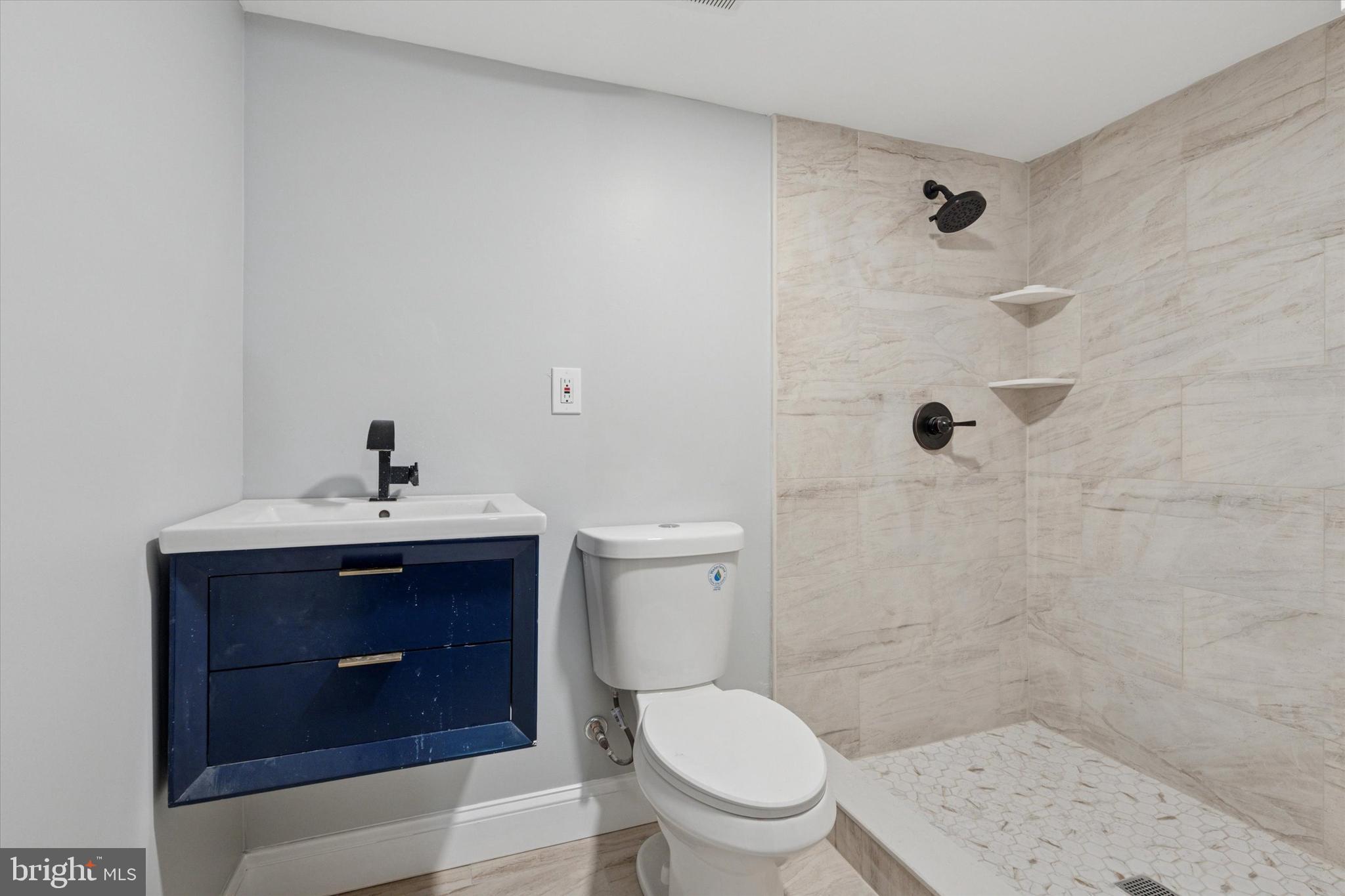 3448 Amber Street Philadelphia, PA 19134 - Photo 26 of 29 a bathroom with a sink a toilet and shower