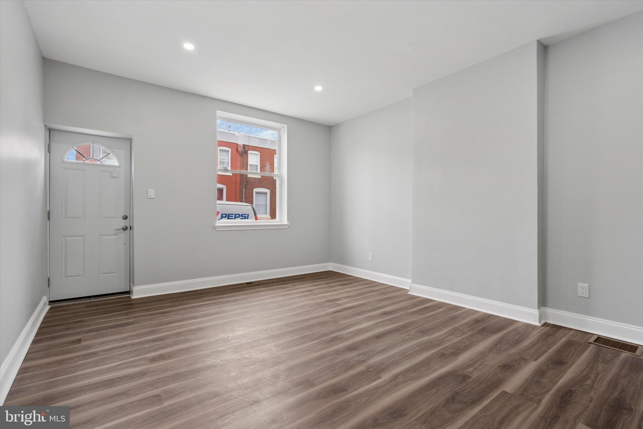 3448 Amber Street Philadelphia, PA 19134 - Photo 5 of 29 a view of an empty room with wooden floor and a window