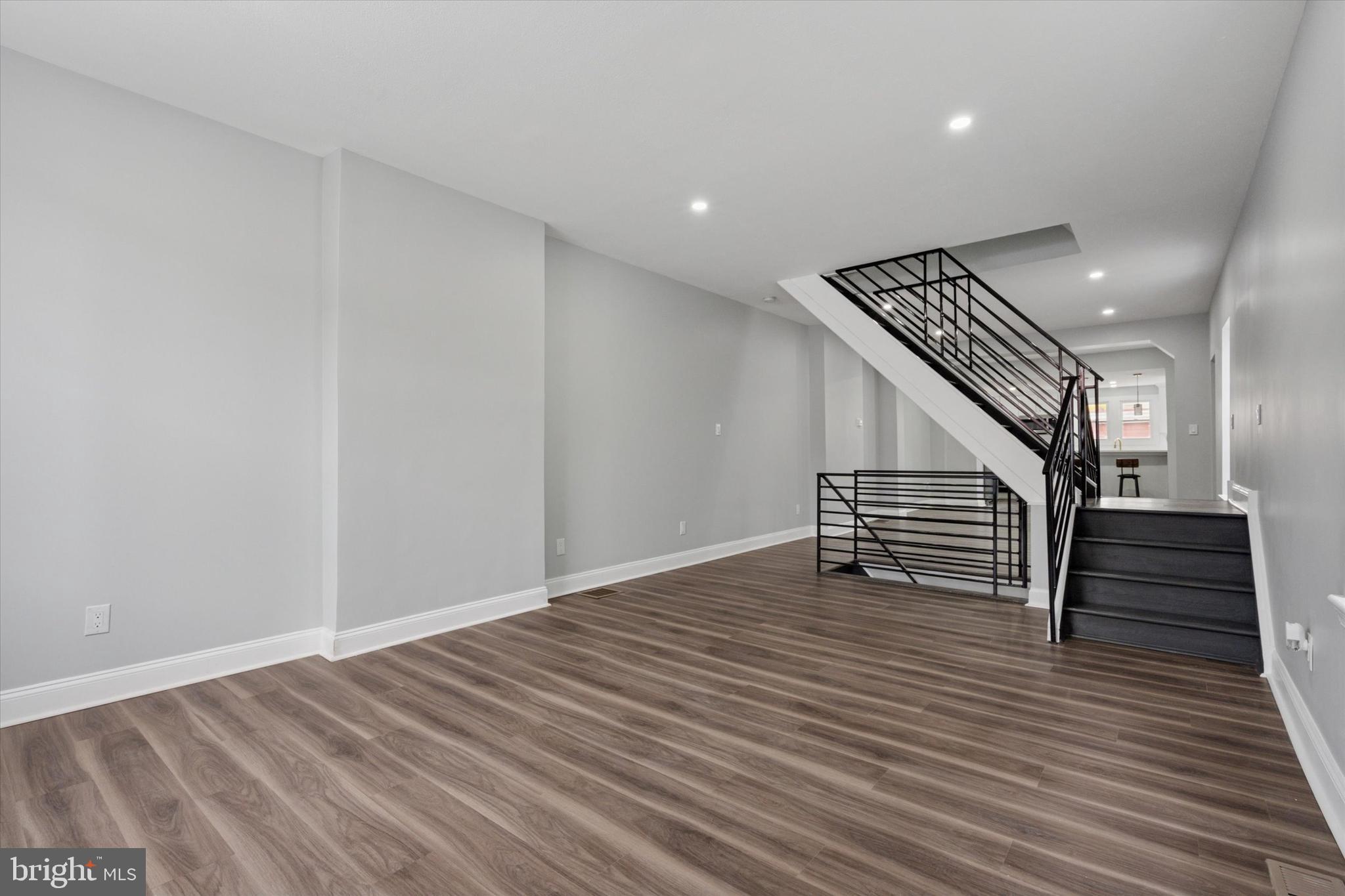 3448 Amber Street Philadelphia, PA 19134 - Photo 8 of 29 a view of an empty room with wooden floor and stairs