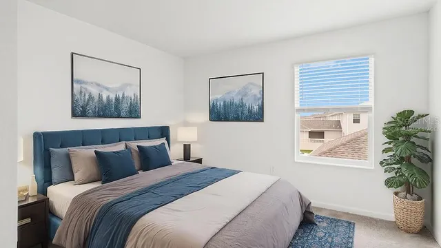 a bedroom with bed and a potted plant