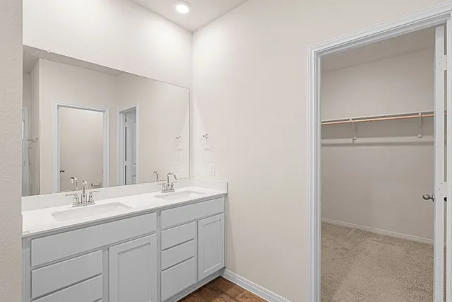 a bathroom with a double vanity sink mirror and