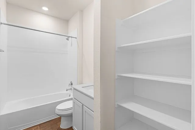 a bathroom with a shower a toilet and a tub