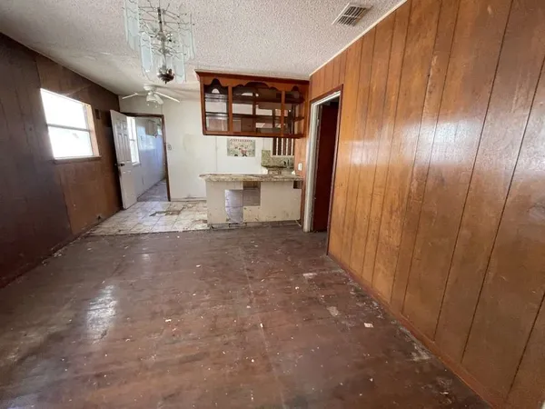 a view of a hallway with stairs and a window