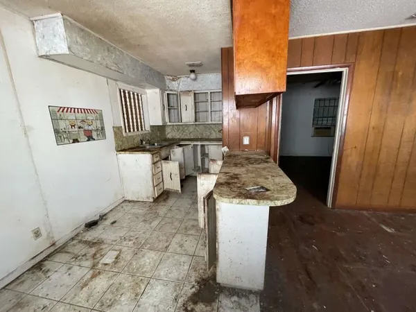 a kitchen with a sink and cabinets