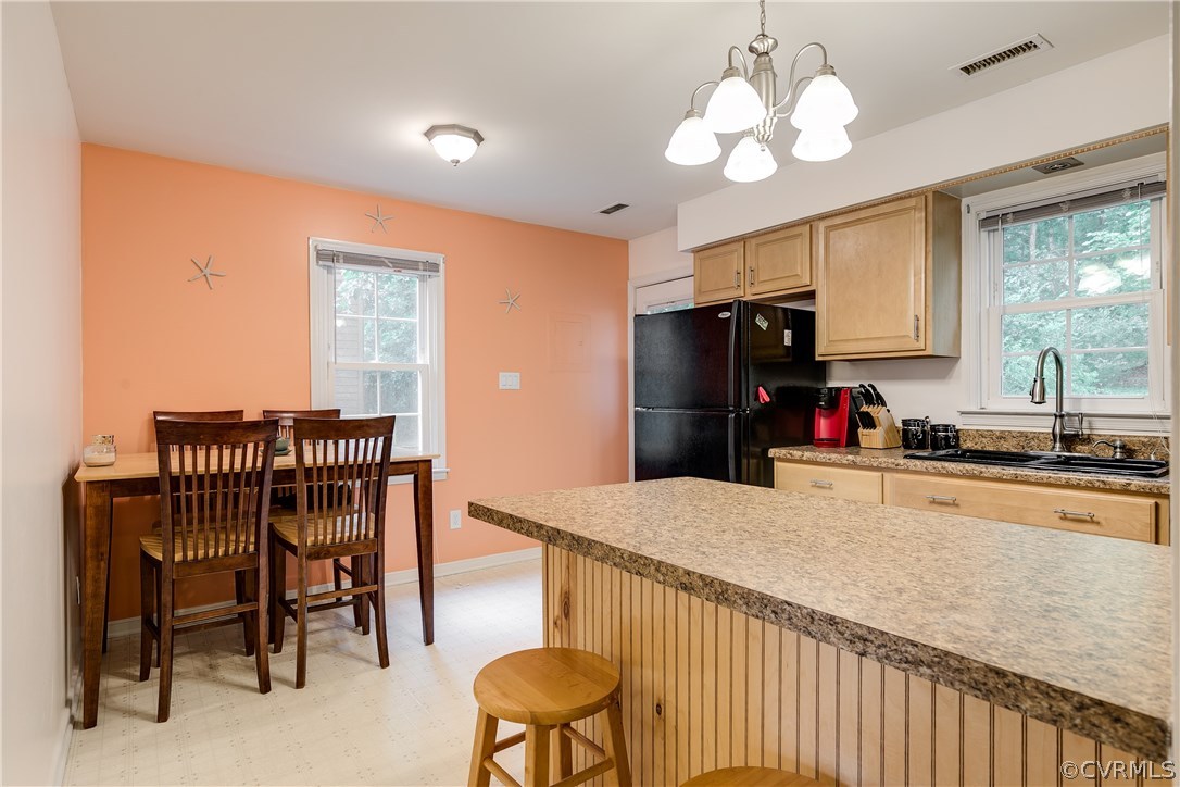 6531 Jessup Road Richmond, VA 23234 - Photo 8 of 29 a kitchen with a chandelier furniture and a refrigerator